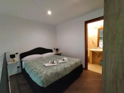 a bedroom with a bed with two towels on it at Charming Trastevere Sun in Rome