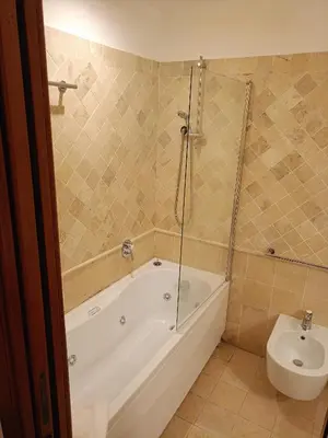 a bathroom with a tub and a toilet and a sink at Charming Trastevere Sun in Rome