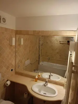 a bathroom with a sink and a tub at Charming Trastevere Sun in Rome