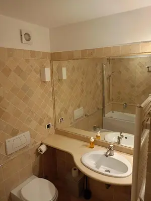 a bathroom with a sink and a toilet and a mirror at Charming Trastevere Sun in Rome