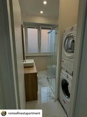 a bathroom with a washer and dryer at Rome s finest in Rome