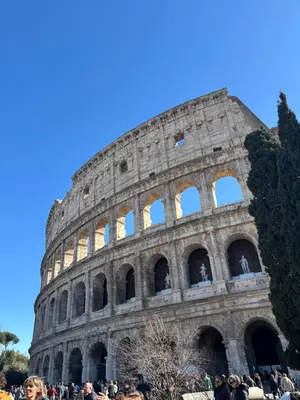 a group of people standing in front of the coliseum at Rome s finest in Rome
