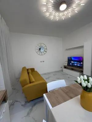 a living room with a yellow couch and a television at Rome s finest in Rome