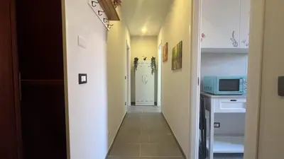 a hallway with a door to a kitchen with a microwave at La casa dell'artista in Rome