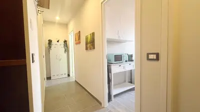 a small kitchen with a microwave and a stove at La casa dell'artista in Rome