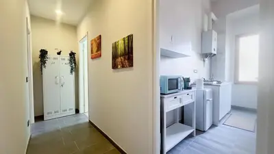 a small kitchen with a sink and a microwave at La casa dell'artista in Rome
