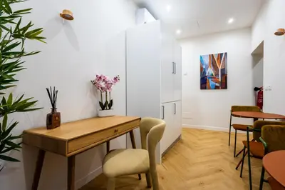a dining room with a wooden table and chairs at Barberini Design Suites in Rome
