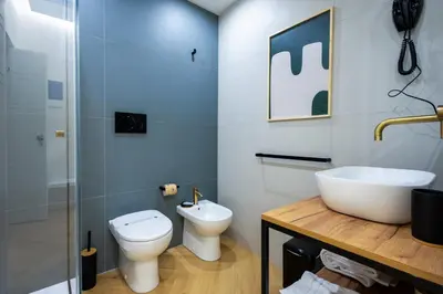 a bathroom with a toilet and a sink at Barberini Design Suites in Rome