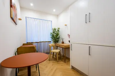 a kitchen with a table and a small table and chairs at Barberini Design Suites in Rome