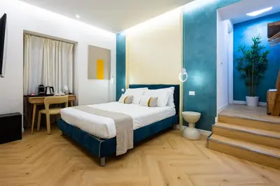 a hotel room with a bed and a desk at Barberini Design Suites in Rome