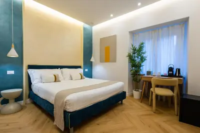 a hotel room with a bed and a desk and a desk at Barberini Design Suites in Rome