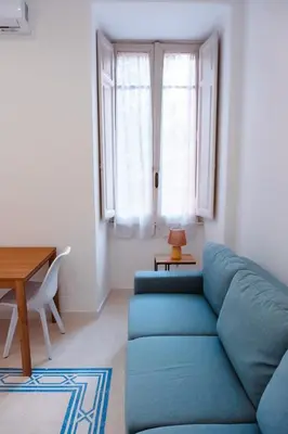 a living room with a blue couch and a table at VG Apartment - Re di Roma in Rome