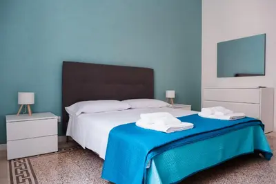 a bedroom with a bed with two towels on it at VG Apartment - Re di Roma in Rome