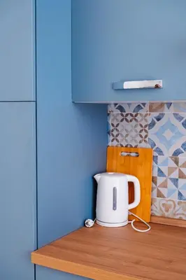 a white toaster sitting on top of a kitchen counter at VG Apartment - Re di Roma in Rome