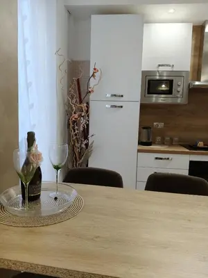 a table with a wine glass and a wine bottle at Metro Re di Roma Apartment in Rome