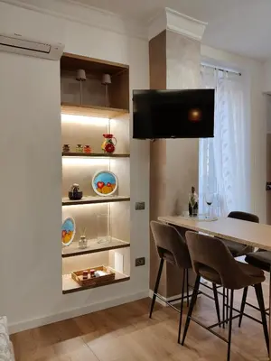 a dining room with a table and chairs at Metro Re di Roma Apartment in Rome