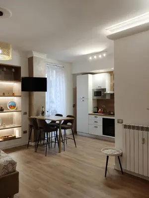a kitchen and dining room with a table and chairs at Metro Re di Roma Apartment in Rome