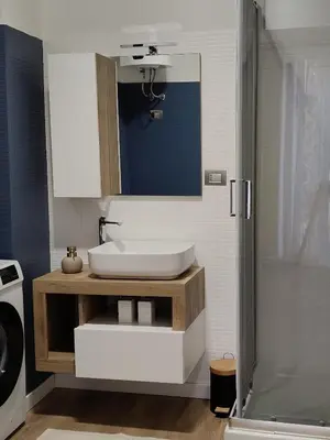 a bathroom with a sink and a shower at Metro Re di Roma Apartment in Rome
