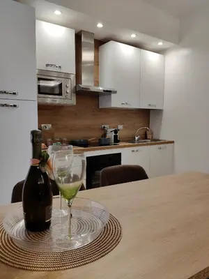 a bottle of wine and a glass on a table at Metro Re di Roma Apartment in Rome