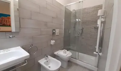 a bathroom with a toilet and a sink and a shower at Vatican Rooms Cipro 2 in Rome
