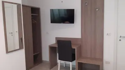 a room with a desk with a chair and a television at Vatican Rooms Cipro 2 in Rome