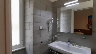 a bathroom with a sink and a mirror at Vatican Rooms Cipro 2 in Rome