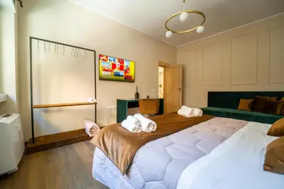 a bedroom with a large bed with towels on it at Les Maisons De Thomas Vaticano in Rome
