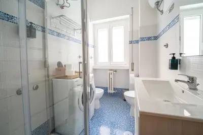 a bathroom with a toilet and a sink and a shower at Les Maisons De Thomas Vaticano in Rome