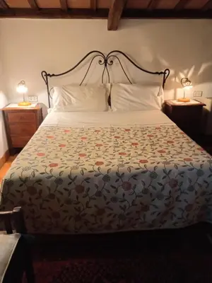 a bedroom with a bed with a floral bedspread at Roman Babuino Inn in Rome
