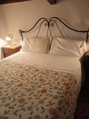 a bedroom with a bed with a floral bedspread at Roman Babuino Inn in Rome