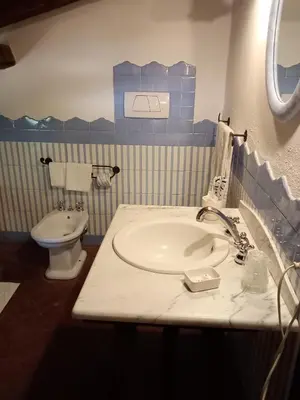 a bathroom with a sink and a toilet at Roman Babuino Inn in Rome