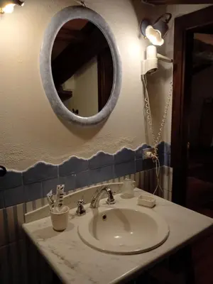 a bathroom with a sink and a mirror on the wall at Roman Babuino Inn in Rome
