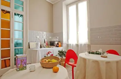 a room with two tables and a bowl of fruit on a table at La Casa di Bru - Cinque Camere - Dieci posti - Terrazzo in Rome