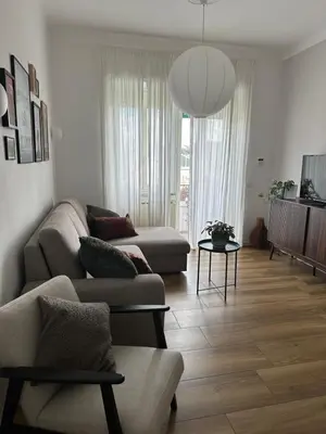 a living room with a couch and a table at Rhome Holiday Home Casal Bertone in Rome