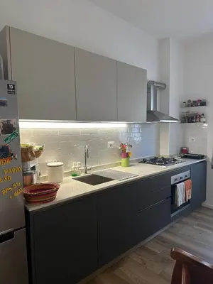 a kitchen with a sink and a stove at Rhome Holiday Home Casal Bertone in Rome