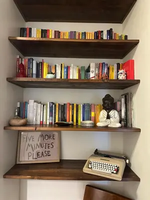 a book shelf with a keyboard and a sign at Rhome Holiday Home Casal Bertone in Rome