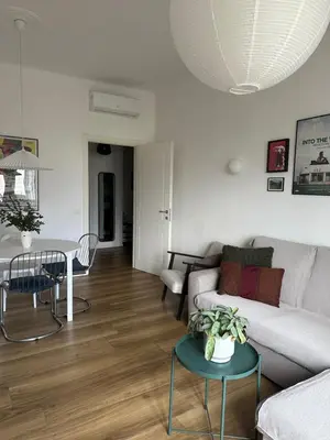 a living room with a couch and a table at Rhome Holiday Home Casal Bertone in Rome