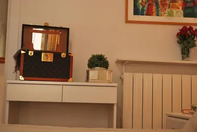 a dresser with a mirror and a suitcase on it at Attico 203 in Rome