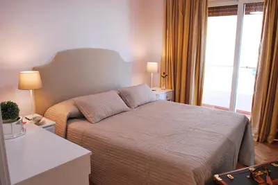 a bedroom with a bed and a large window at Attico 203 in Rome