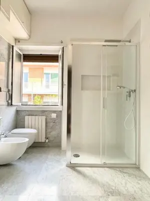 a bathroom with a shower and a toilet and a sink at Attico 203 in Rome