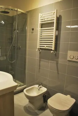 a bathroom with a toilet and a sink and a shower at Attico 203 in Rome
