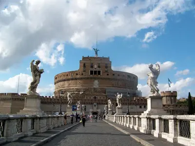 a building with statues in front of a bridge at Attico 203 in Rome