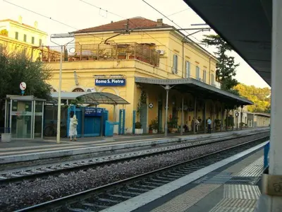 a train station with people waiting on the tracks at Attico 203 in Rome