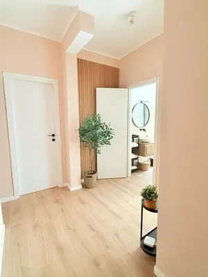 an empty room with a door and a plant at Santa Maria Apartment Rome in Rome