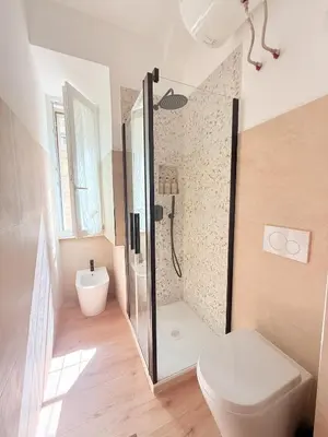 a bathroom with a shower with a toilet and a sink at Santa Maria Apartment Rome in Rome