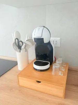 a coffee maker sitting on top of a wooden stand at Santa Maria Apartment Rome in Rome