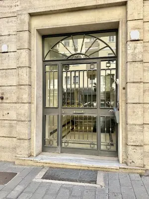 a large glass door of a building at Santa Maria Apartment Rome in Rome