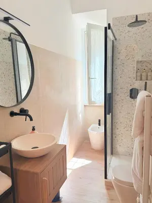 a bathroom with a sink and a mirror at Santa Maria Apartment Rome in Rome