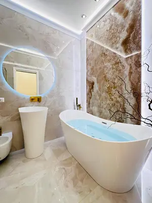 a bathroom with a tub and a mirror at Trevi Fountain Elegant Suites by Marianna in Rome