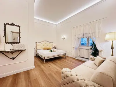 a white living room with a couch and a mirror at Trevi Fountain Elegant Suites by Marianna in Rome